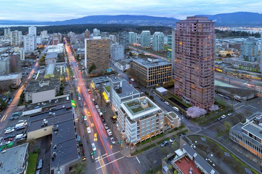 Vancouver British Columbia Canada Cityscape with Robson Street Light Trails and Stanley Park View at Dusk
