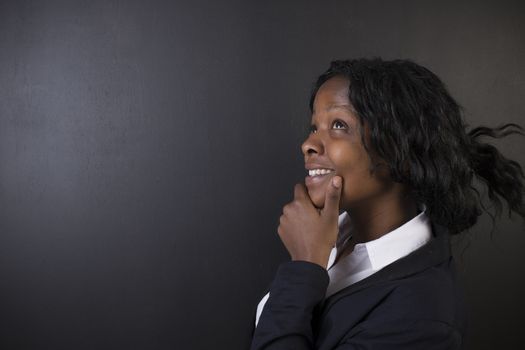 South African or African American woman teacher or student think or thinking on chalk black board background
