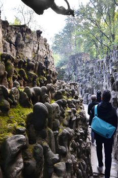 Chandigarh, India - January 4, 2015: Tourist visit Rock statues at the rock garden on January 4, 2015 in Chandigarh, India. The rock garden was founded by artist Nek Chand in 1957 and is made completely of recycled waste.