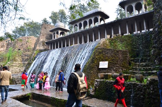 Chandigarh, India - January 4, 2015: People visit Rock statues at the rock garden on January 4, 2015 in Chandigarh, India. The rock garden was founded by artist Nek Chand in 1957 and is made completely of recycled waste.