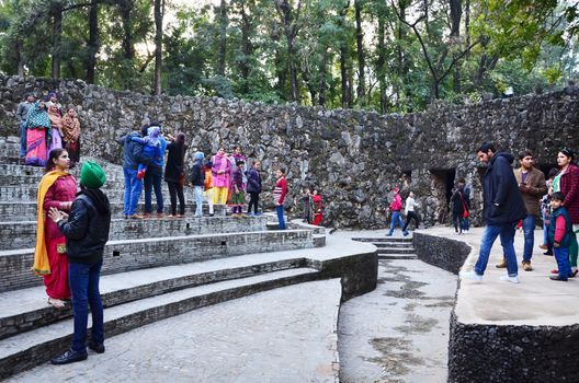 Chandigarh, India - January 4, 2015: People visit Rock statues at the rock garden on January 4, 2015 in Chandigarh, India. The rock garden was founded by artist Nek Chand in 1957 and is made completely of recycled waste.