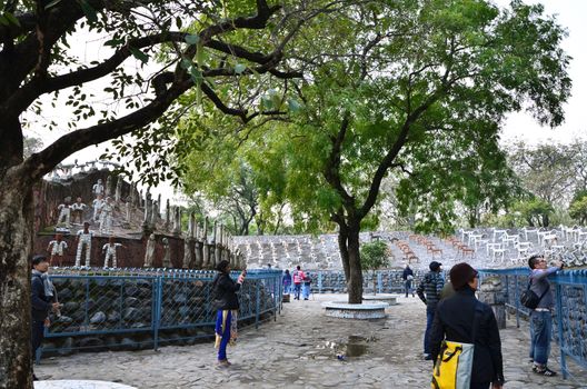 Chandigarh, India - January 4, 2015: People visit Rock statues at the rock garden on January 4, 2015 in Chandigarh, India. The rock garden was founded by artist Nek Chand in 1957 and is made completely of recycled waste.