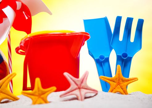 Colorful plastic toys on the beach