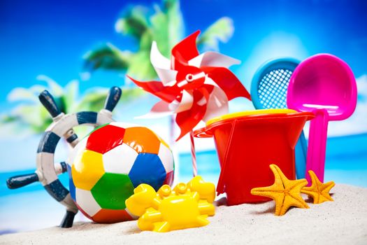 Colorful plastic toys on the beach