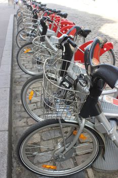 Velo'v Grand Lyon - Vélo'v is a bicycle sharing system run by the city of Lyon (France). 		Shared Bikes Are Lined Up In The Street 
