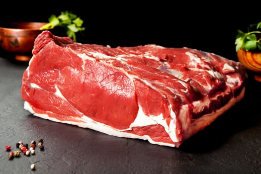 Fresh and raw meat. Ribeye. Fresh whole piece of steak on black background blackboard