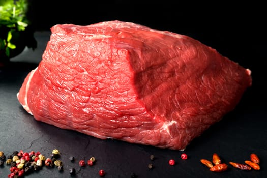 Pork uncooked fresh beef and veal. Fresh red meat spiced black stone background