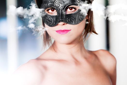portrait of beautiful young woman with carnival mask on Cloud Background. Fashion and Fantasy