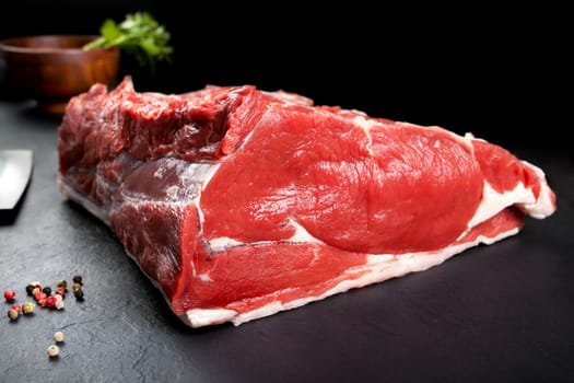 Fresh and raw meat. Ribeye. Fresh whole piece of steak on black background blackboard. Food