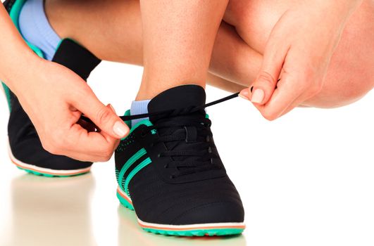 Running shoes being tied by woman, white background, isolated, copyspace