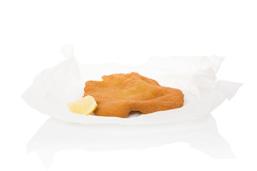 Delicious wiener schnitzel on baking paper isolated on white background. Fresh modern image language. Culinary arts. 