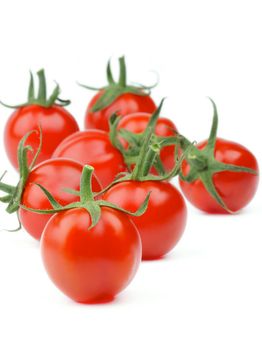 Perfect Ripe Cherry Tomatoes with Stems isolated on white background. Focus on Foreground