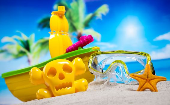 Colorful plastic toys on the beach