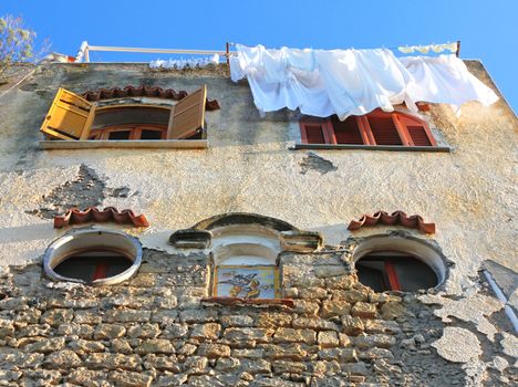 Italy. Campania region. Procida island. Mediterranean stone house of Corricella  in evening sunlight