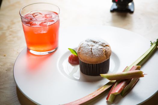 Rhubarb and ginger muffins on white plate