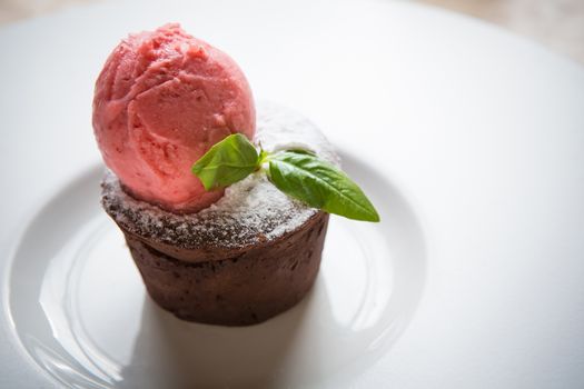 Warm dessert chocolate cake Fondant served on plate with ice-cream ball