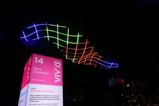 SYDNEY, AUSTRALIA - MAY 27, 2015; The Circular Quay walkway illuminated by this beautiful colourful wave form chandelier  that changes colours in a flowing form.  Artist Mark Dyson, Oliver Tanner
