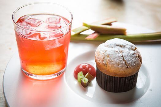 Rhubarb and ginger muffins on white plate