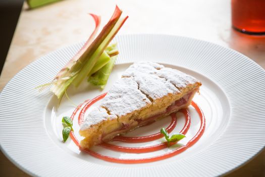 delicious rhubarb cake on white plate. sweet food