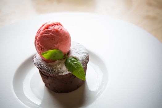 Warm dessert chocolate cake Fondant served on plate with ice-cream ball