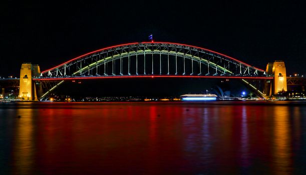 SYDNEY, AUSTRALIA - MAY 21, 2015;  Sydney Harbour Bridge lights up in vivid reds for Vivid Sydney 2015 and a harbour of vivid red water as well