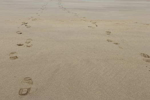 foot prints in the sand to symbolise love and friendship