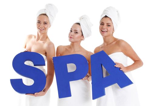 beautiful young women holding spa letters