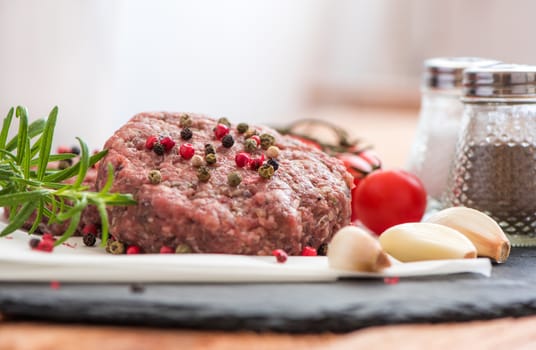 Raw Minced Hamburger Meat with Herb and Spice Prepared for Grilling