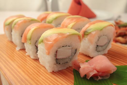 salmon sushi on wooden plate