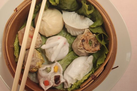 wontons in wooden bowl with sticks