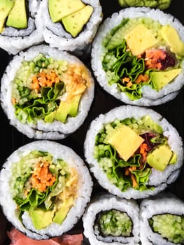 Close-up of tasty vegetarian sushi on dark background.