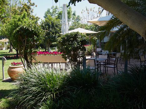 Romantic beautiful summer outdoor cafe in a lush green garden