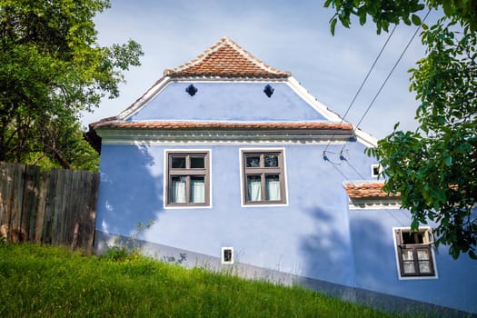 Viscri, Romania - June 23, 2013: Blue painted traditional house from Viscri village in Transylvania, Romania