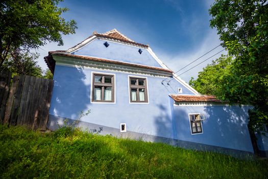 Viscri, Romania - June 23, 2013: Blue painted traditional house from Viscri village in Transylvania, Romania