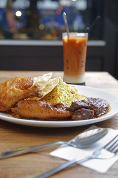 Malaysian cuisine, rice with chicken and beef in chili sauce.