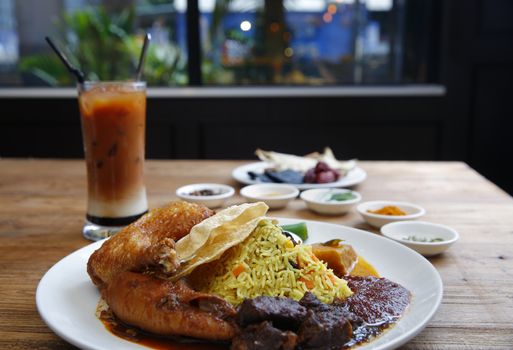 Malaysian cuisine, rice with chicken and beef in chili sauce.