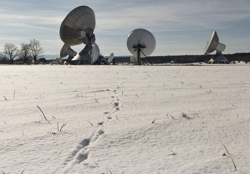 Some tracks in the snow leading to the dishes