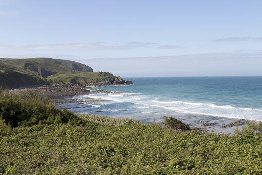 A bay in Normandy with some waves on the beach