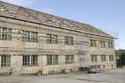 renovation of an old building with scaffolding on the facade