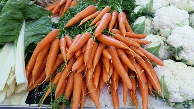 A variety of fresh carrots for sale at a local market. Marché Saint-Antoine Célestins 
