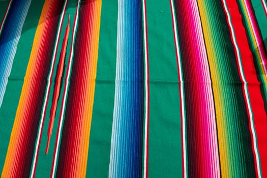 Typical traditional colorful Mexican festive fabric cloth on display                               