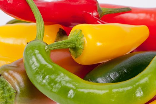 heap of colorful raw chili pepper isolated on white background