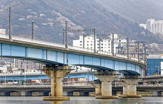 train bridge across river and city background at busan , korea