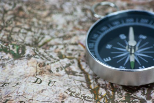 Close up of a compass on an old map