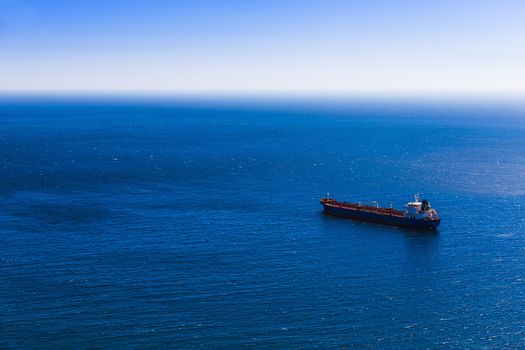Empty container cargo ship in the blue sea. Aerial view