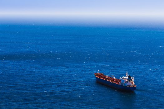 Aerial view to empty container cargo ship in the blue ocean