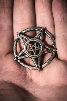 Old steel Pentagram closeup photo on background