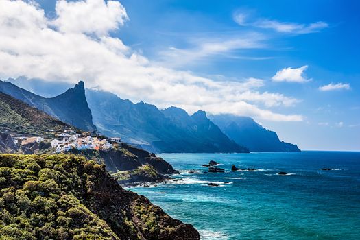 Coast or shore of Atlantic ocean with  rock and blue sky with clouds and horizon in Tenerife Canary island, Spain at spring or summer