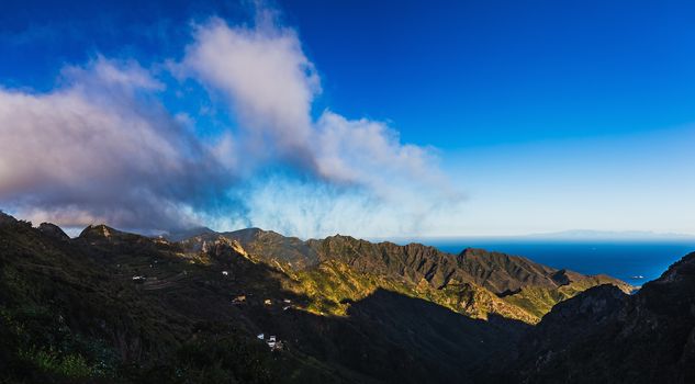 Clouds and mountains or rocks with blue sky horizon background near the Atlantic ocean landscape in Tenerife Canary island, Spain