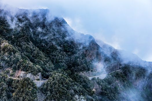 Landscape with clouds over mountain with serpantine road in Tenerife Canary island, Spain